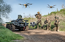 A group of soldiers standing next to a robotics and autonomous vehicle.