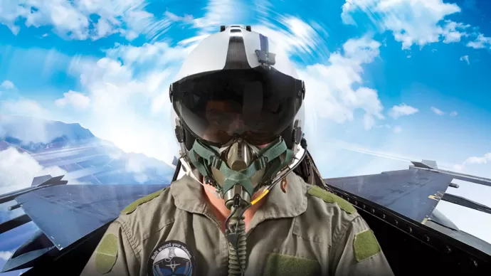 Pilot with helmet sitting in the cockpit