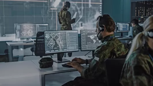 a man sitting at his desk in front of a computer